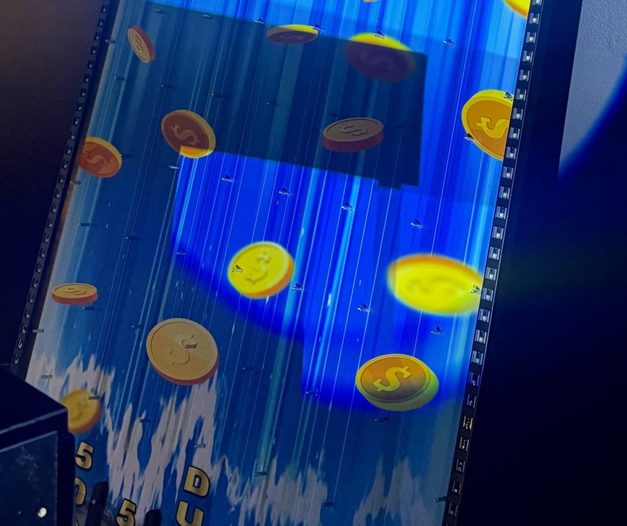 The Jackpot Falls drop board lit up in the ClueClock Gameshow room